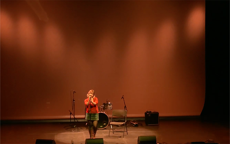 A woman singing on stage