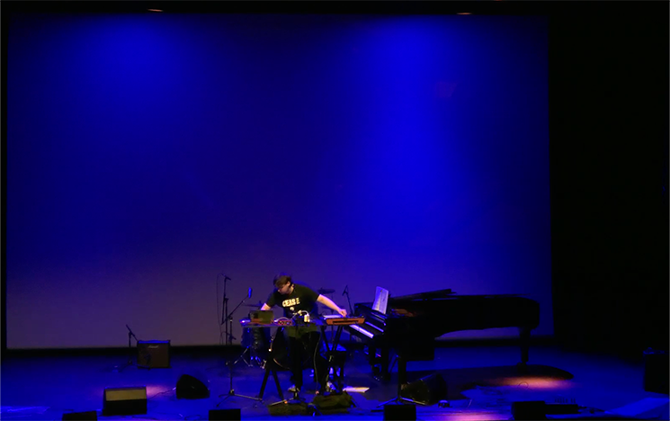 A man mixing music on stage