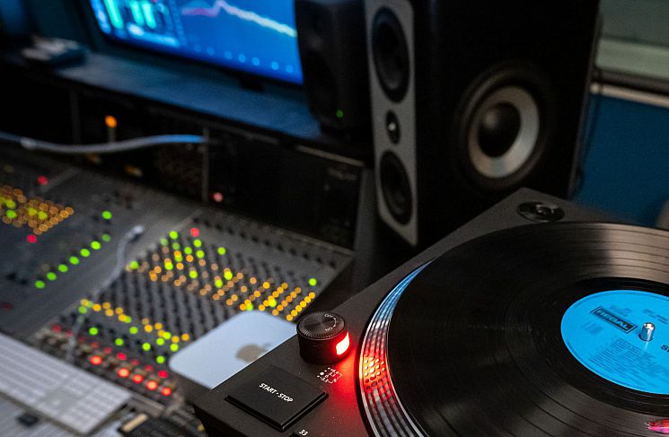 Music Studio 1, featuring a record being played, speakers, computer, screen and mixing desk