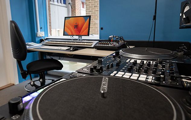 DJ decks, keyboard and computer in a studio