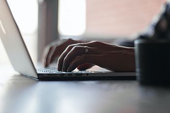photo of someone using a laptop