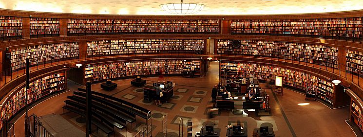 Picture of a large open library space in dim light.