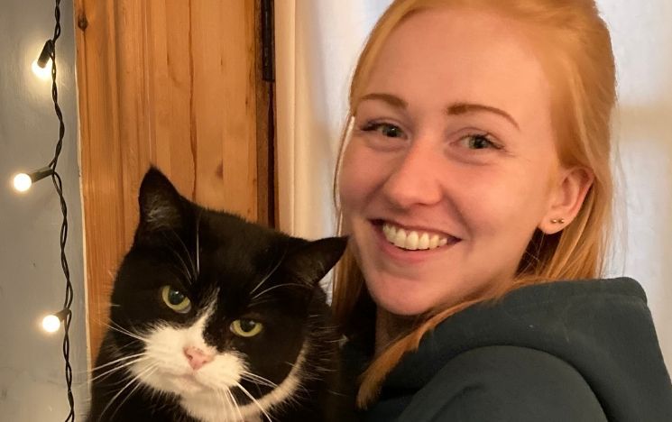 PhD student Jemma Forman with a cat in her arms