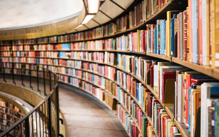 Library shelves curving into distance.