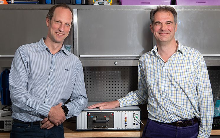 Professor Peter Kruger with industry partner Gary Kendall with battery density analyser