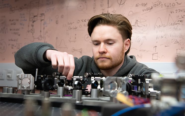 A PhD student with his optic set up