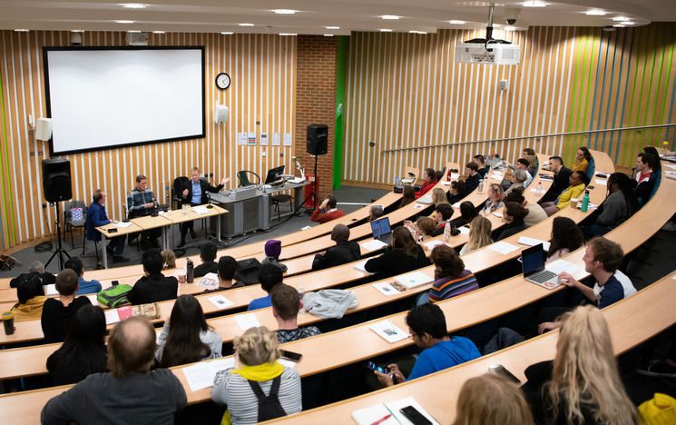 Audience in Fulton lecture theatre listening to speakers