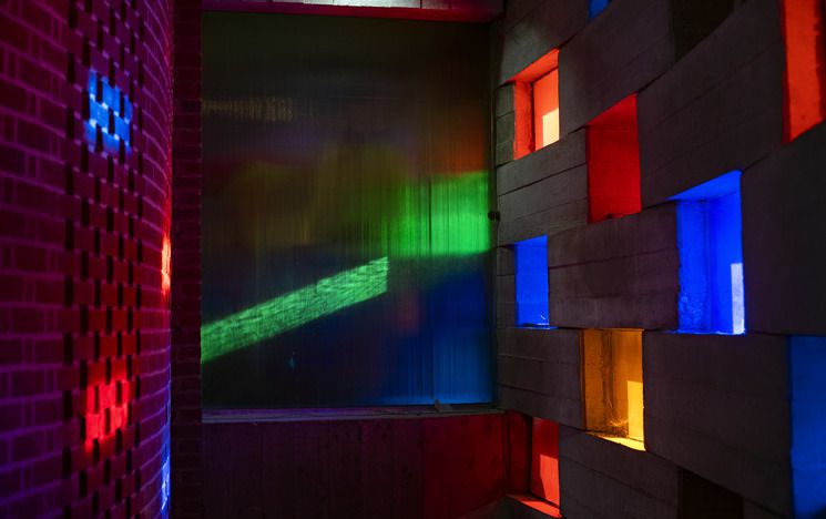 Light coming through coloured blocks of the Meeting House