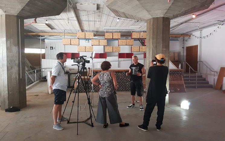 Camera crew in the undercroft of the Southbank filming a person talking to camera