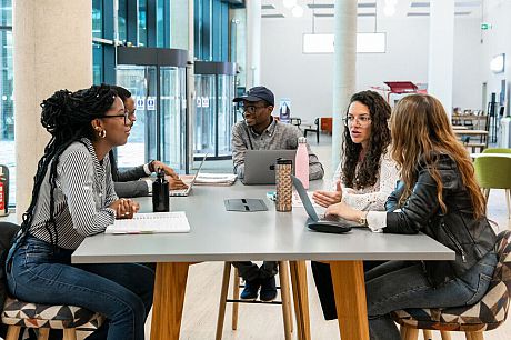 This image shows Sussex students working in a group at the student centre