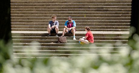 Sussex students relaxing and talking on campus