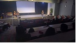 Actors sit on stage during Q&A