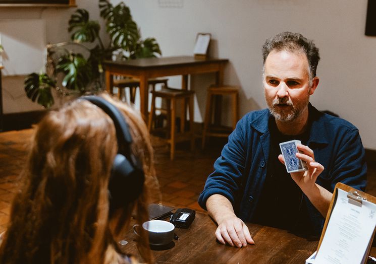 Photo of Augusto Corrieri showing someone a card.