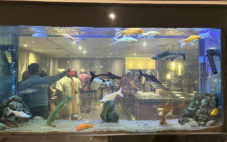 Breakfast hall seen though fish tank in Pakistan hotel