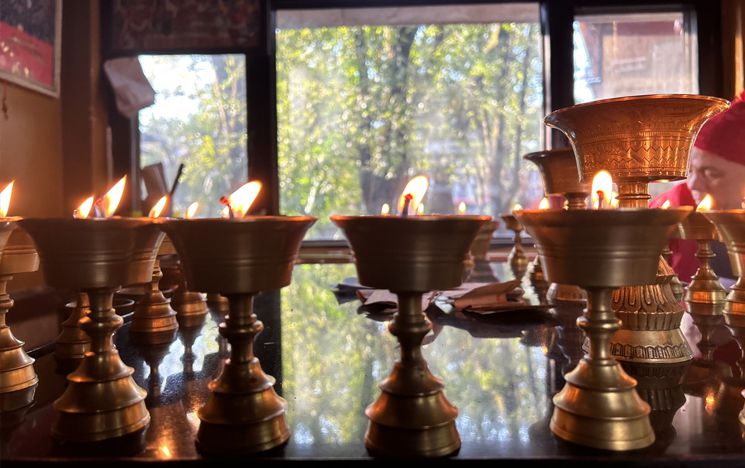 Diya lit in veneration at Buddhist shrine complex, McLeod Ganj.