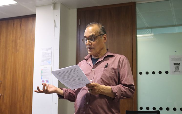 One of the actors reading an excerpt from the collection of 1984 survivor narratives out loud