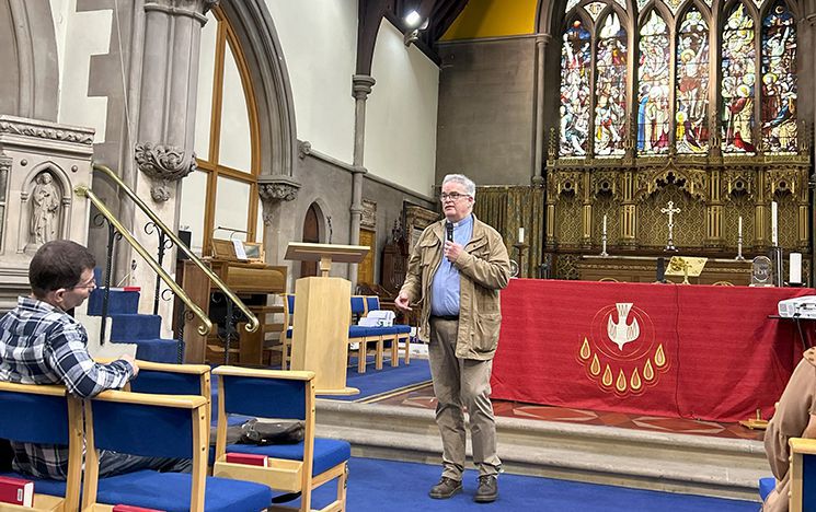 Revd David Gould talking to pilgrims inside Holy Trinity Church, Smethwick