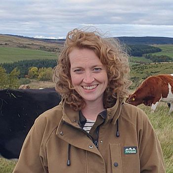 Portrait of regenerative farmer, Nikki Yoxall, smiling to camera in field