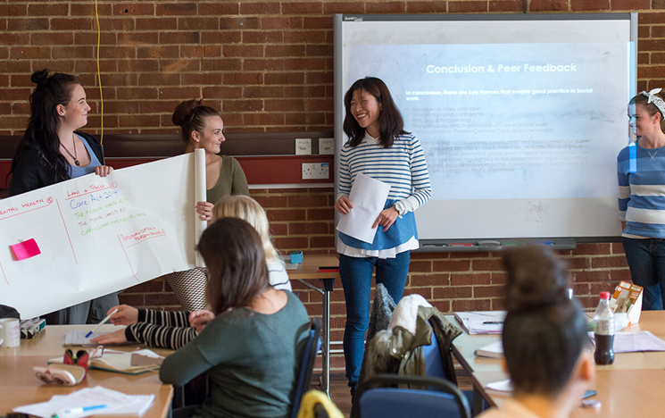 A group of students present in class
