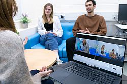 Researcher talking to two participants while recording their facial expressions