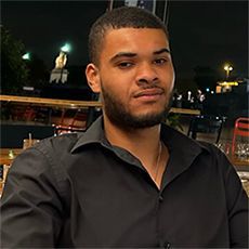 Headshot of a man wearing a black shirt