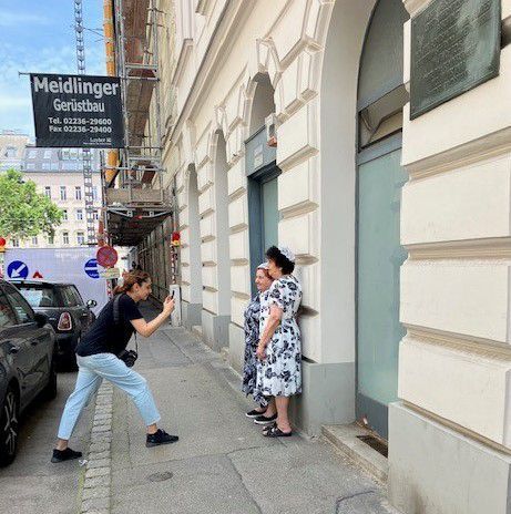 Project photographer, Moska Najib, taking a photo of a person during a trip to Vienna