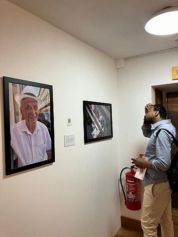 A person looking at one of the photos hung up at the exhibition