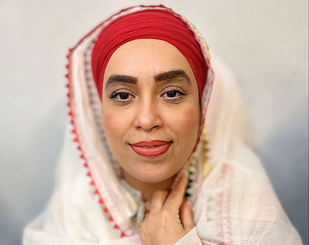 Portrait of a woman in a red and white head scarf