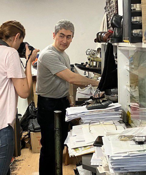 Moska Najib taking a photo of a shoe repair man