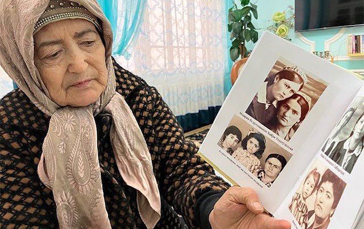 a woman looking at old photographs