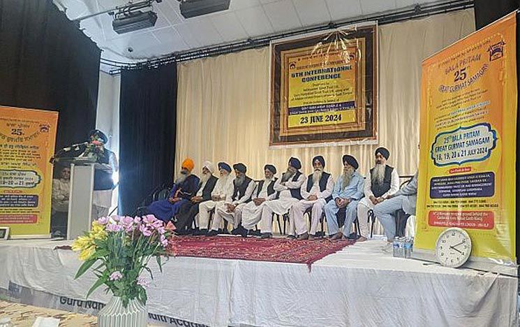 some people arranged on a stage for an event in a large hall