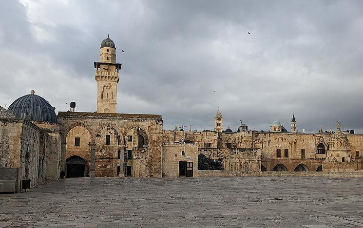 a townscape showing ancient, religious buildings of pale stone
