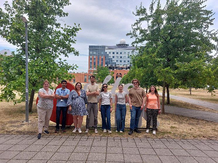 A group of people standing in front of a building at Eötvös Loránd University 