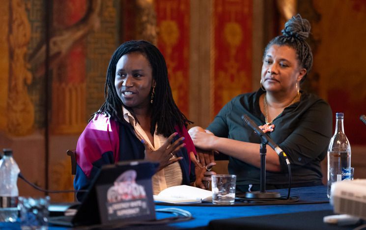 Two people of colour on panel in the Royal Pavilion, Brighton