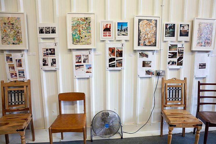 A wall with photos and posters at the You Can Make History exhibition