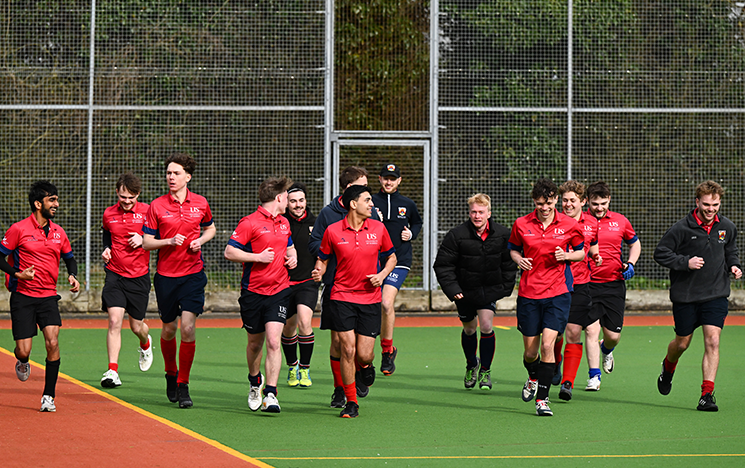Sussex students running on the pitch at Falmer Sports Complex
