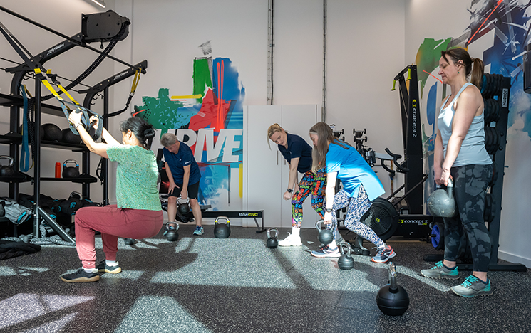 Staff using weights and pulling straps in Active Arches