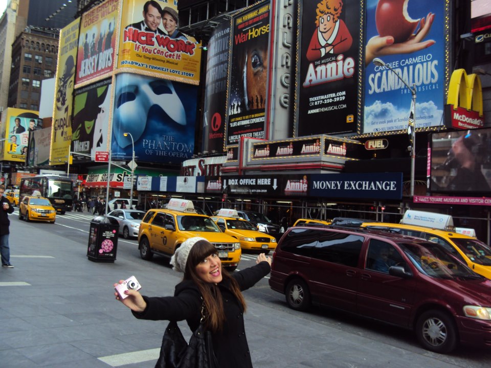 A female Sussex student smiling in Times Square, New York