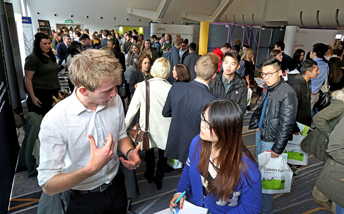 A Sussex student talking to a potential graduate employer at our annual graduate careers fair