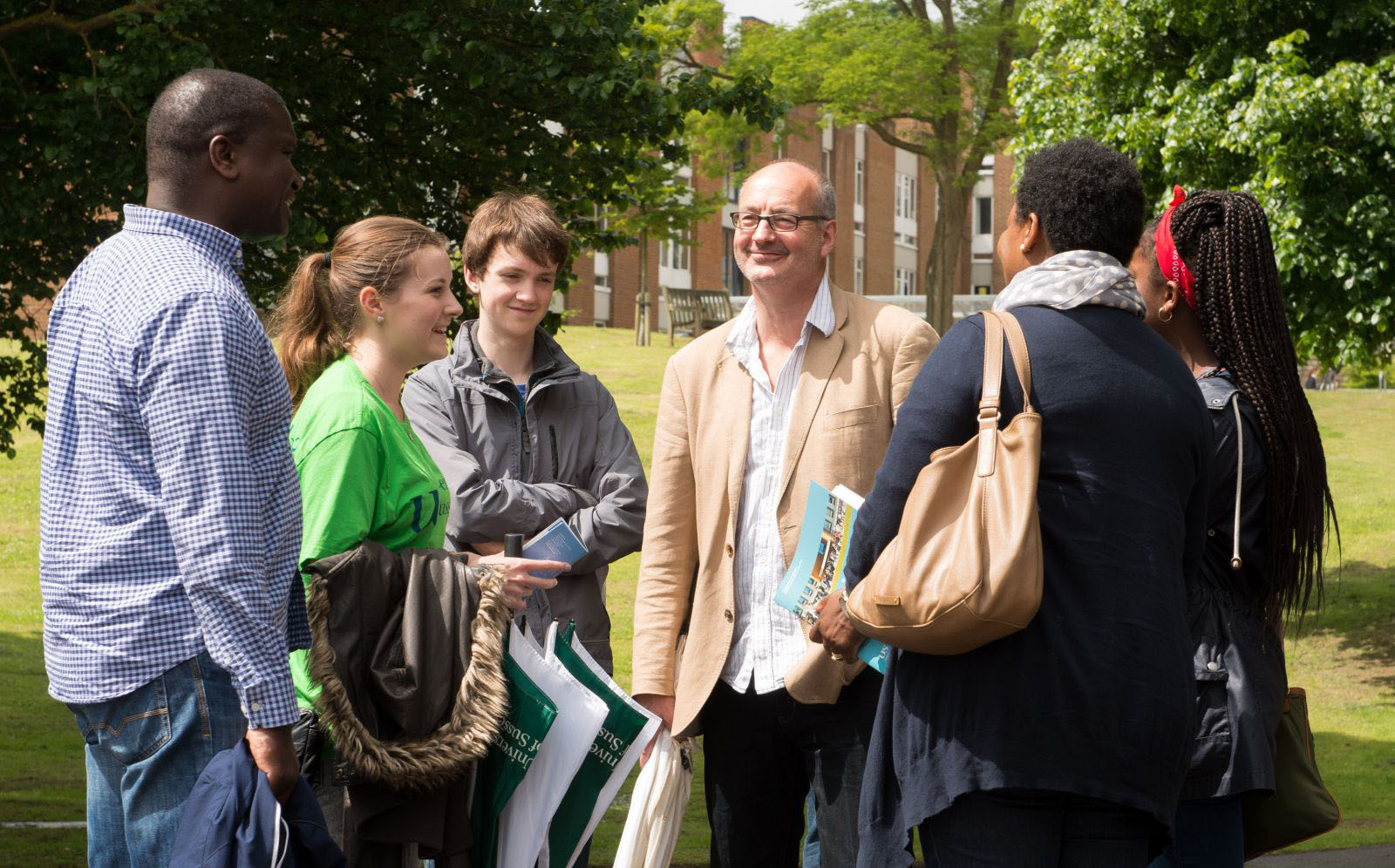 A group of people being shown around the University of Sussex campus by one of our guides