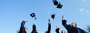 Undergraduate students in the Department of Education at Sussex at graduation, throwing their mortar boards into the air