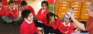 A group of primary school children with a Sussex academic, representing our Education research