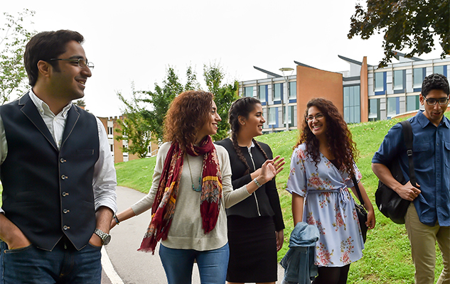 A group of Sussex international students walking on Sussex campus