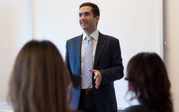 A suited man giving a presentation