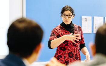 A teacher discusses a topic with students