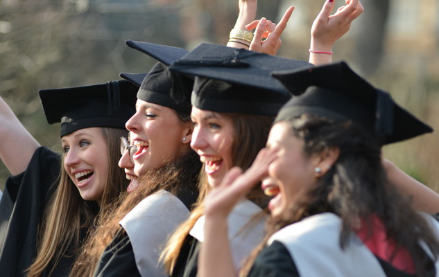 A group of female students celebrating at a graduation ceremony