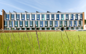 One end of the Jubilee building, with blades of grass in the foreground