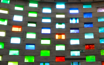 The coloured window panes of the Meeting House letting daylight through