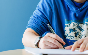 A man writing an application for a job