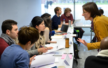 A group of people listen to a presentation